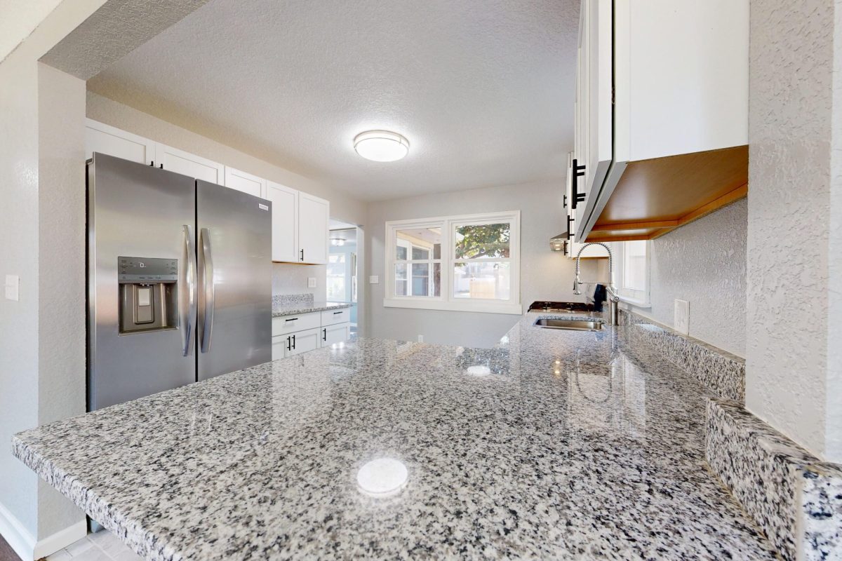 Spacious kitchen featuring granite countertops and stainless steel appliances.